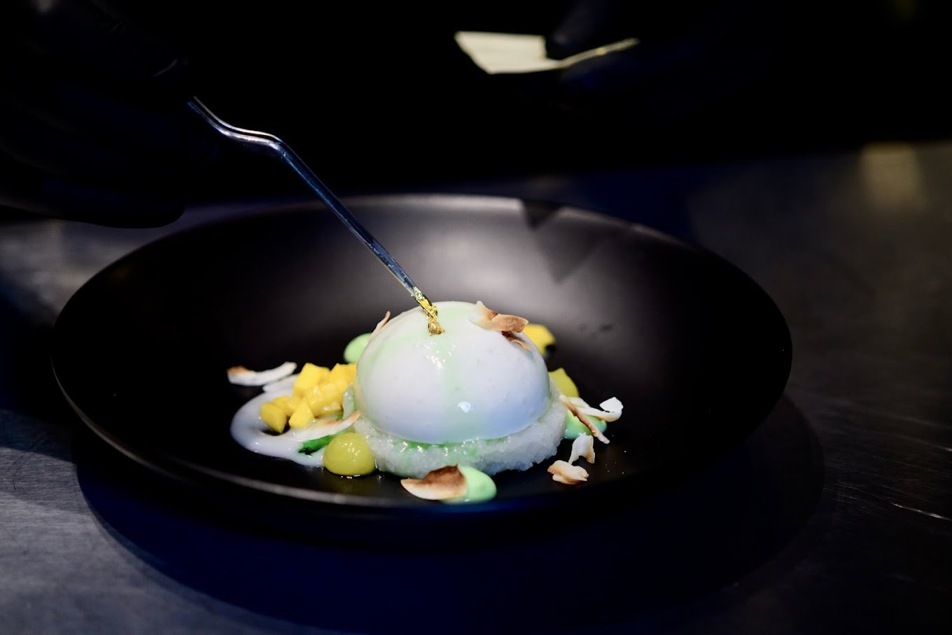white round dessert on a black plate